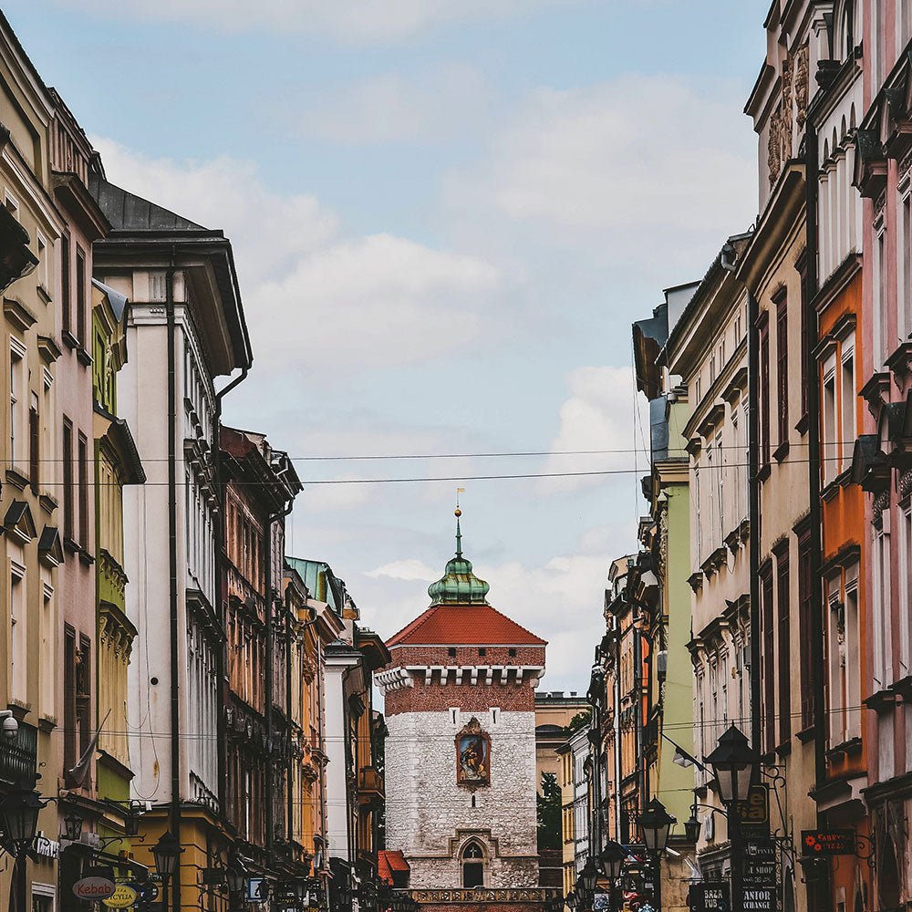 Colourful old European street leading to a historic gate tower
