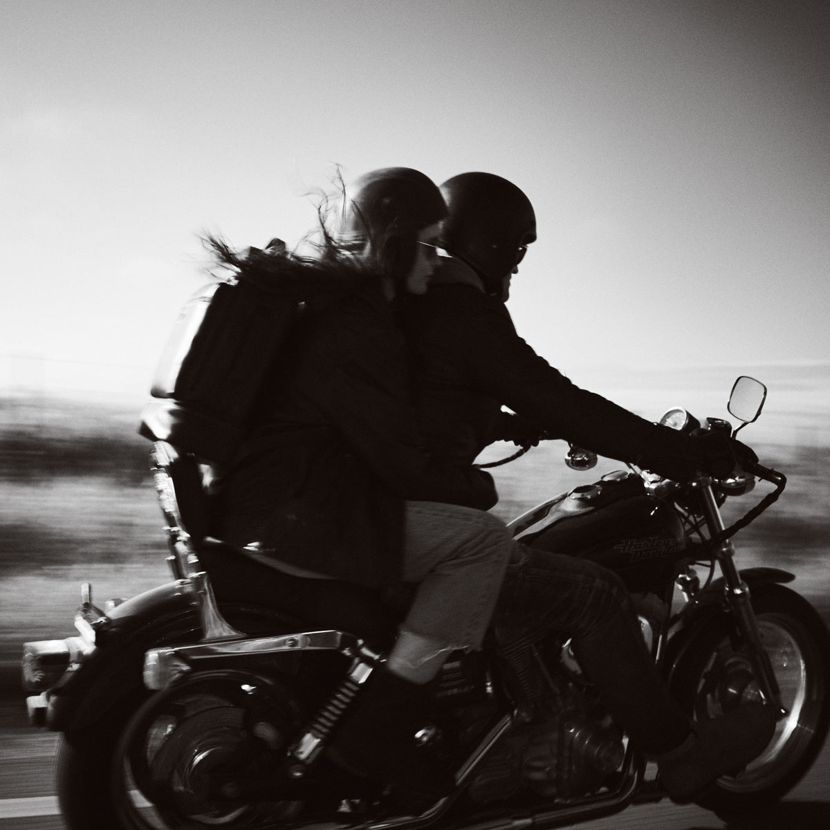 Black and white motion shot of riders on a motorbike with the James Laptop Backpack
